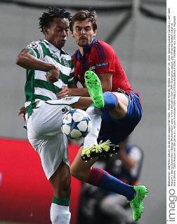 MOSCOW REGION, RUSSIA. AUGUST 26, 2015. Sporting s Andre Carrillo (L) and CSKA Moscow s Georgi Schennikov (Georgy Shchennikov) jump to kick the ball in their UEFA Champions League play-off series football match at Arena Khimki. CSKA Moscow won the game 3-1. Artyom Korotayev TASS  TS00B83E