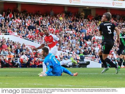 Arsenal s Theo Walcott scoring his sides opening goal Barclays Premier League- Arsenal vs Stoke City - Emirates Stadium - England - 12th September 2015 - Picture David Klein Sportimage EDITORIAL USE ONLY. No use with unauthorised audio, video, data, fixture lists, club league logos or live services. Online in-match use limited to 120 images, no video emulation. No use in betting, games or single club league player publications.