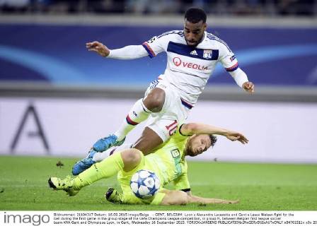 - GENT, BELGIUM: Lyon s Alexandre Lacazette and Gent s Lasse Nielsen fight for the ball during the first game in the group stage of the Uefa Champions League competition, in group H, between Belgian first league soccer team KAA Gent and Olympique Lyon, in Gent, Wednesday 16 September 2015. YORICKxJANSENS x04701511x
