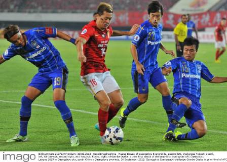 Huang Bowen of Guangzhou Evergrande, second left, challenges Takashi Usami, left, Oh Jae-suk, second right, and Yasuyuki Konno, right, of Gamba Osaka in their first match of the semi-final during the AFC Champions League 2015 in Guangzhou city, south China s Guangdong province, 30 September 2015. Guangzhou Evergrande challenge Gamba Osaka in semi-final of AFC Champions League 20150930_34419