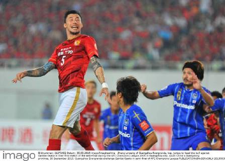 Zhang Linpeng of Guangzhou Evergrande, top, jumps to head the ball against Gamba Osaka in their first match of the semi-final during the AFC Champions League 2015 in Guangzhou city, south China s Guangdong province, 30 September 2015. Guangzhou Evergrande challenge Gamba Osaka in semi-final of AFC Champions League  20150930_12466