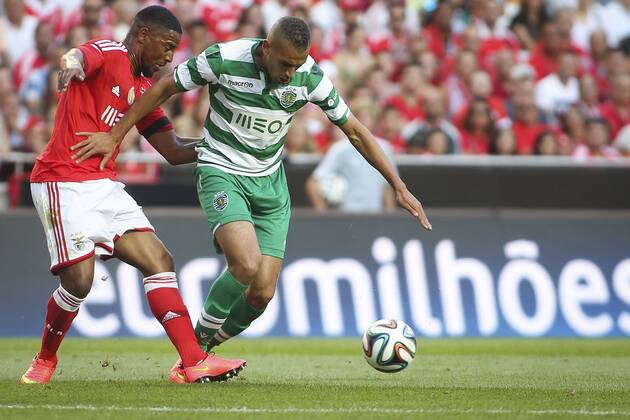 Aug. 31, 2014 - Lisbon, Portugal - Sporting«s forward Islam Slimani (R) challenges Benfica«s defender Eliseu during the Portuguese Liga football match SL Benfica vs Sporting CP at Luz stadium in Lisbon on August 31, 2014. NURPHOTO CARLOS COSTA FBL-LIGA-SPORTING-BENFICA - ZUMAn230