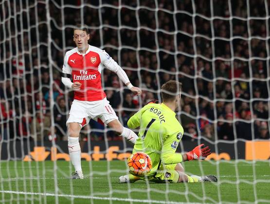 Arsenal s Mesut Ozil scoring his sides second goal Barclays Premier League- Arsenal vs AFC Bournemouth - Emirates Stadium - England - 28th December 2015 - Picture - David Klein Sportimage EDITORIAL USE ONLY. No use with unauthorised audio, video, data, fixture lists, club league logos or live services. Online in-match use limited to 120 images, no video emulation. No use in betting, games or single club league player publications.