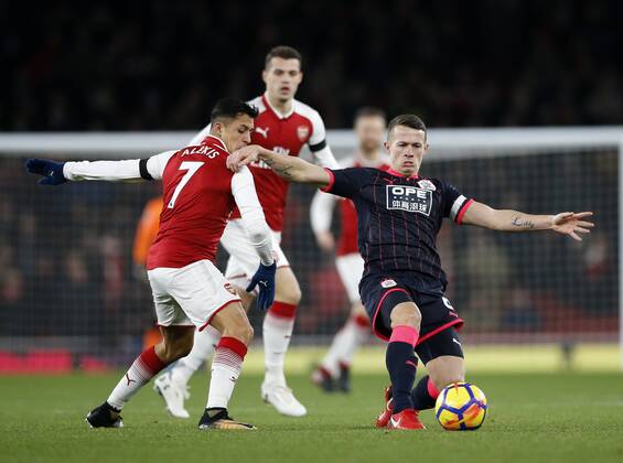 Arsenal s Alexis Sanchez tussles with Huddersfield s Jonathan Hogg during the premier league match at the Emirates Stadium, London. Picture date 29th November 2017. Picture credit should read: David Klein Sportimage EDITORIAL USE ONLY. No use with unauthorised audio, video, data, fixture lists, club league logos or live services. Online in-match use limited to 120 images, no video emulation. No use in betting, games or single club league player publications.