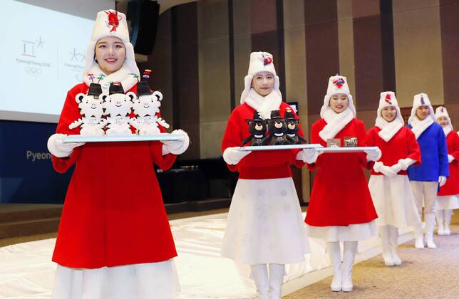 Bilder des Tages - SPORT Pyeongchang Olympics Models donning the outfits for assistants who will carry the medals in awards ceremonies of the Pyeongchang Winter Olympics line up near a podium during a preview in Seoul on Dec. 27, 2017. 