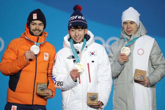 PYEONGCHANG, SOUTH KOREA â€“ FEBRUARY 11, 2018: Silver medallist Sjinkie Knegt of the Netherlands, Gold medallist Lim Hyo-jun of South Korea, and bronze medallist Semyon Yelistratov, Olympic Athlete from Russia, from left, pose at the victory ceremony for the for men s 1500m short track Speed skating Eisschnelllauf event at the 2018 Winter Olympic Games Olympische Spiele Olympia OS at Medals Plaza. Sergei Bobylev TASS  TS0734B1