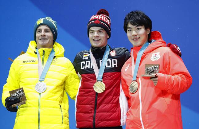 Pyeongchang Olympics Gold medalist Mikael Kingsbury (C) of Canada, silver medalist Matt Graham (L) of Australia and bronze medalist Daichi Hara of Japan attend the medal ceremony for the men s freestyle skiing moguls at the Pyeongchang Winter Olympics in South Korea on Feb. 13, 2018. 