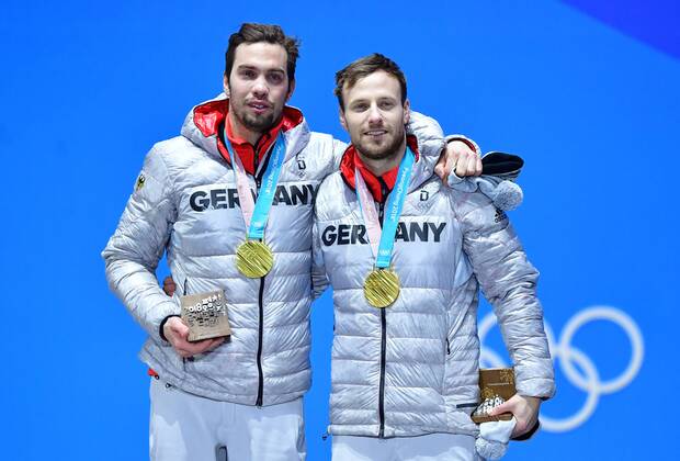 Gold medalist Germany s Tobias Wendl and Tobias Arlt celebrate during the medal ceremony for Luge Doubles at the Pyeongchang 2018 Winter Olympics in Pyeongchang, South Korea, on February 16, 2018.  OLY20180216365 KEVINxDIETSCH