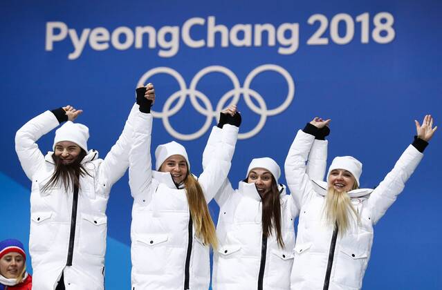 PYEONGCHANG, SOUTH KOREA - FEBRUARY 18, 2018: Bronze medalists, Olympic Athletes from Russia Natalia Nepryaeva, Yulia Belorukova, Anastasia Sedova, and Anna Nechaevskaya (L-R) cheer at a victory ceremony for the ladies cross-country skiing 4x5km relay race at the 2018 Winter Olympic Games Olympische Spiele Olympia OS at the Alpensia Cross-Country Skiing Centre. Valery Sharifulin TASS  TS0747C0