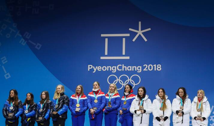PYEONGCHANG, SOUTH KOREA - FEBRUARY 18, 2018: Silver medalists Anna Haag, Charlotte Kalla, Ebba Andersson, Stina Nilsson of Sweden, gold medalists Ingvild Flugstad Oestberg, Astrid Uhrenholdt Jacobsen, Ragnhild Haga, Marit Bjoergen of Norway, and bronze medalists, Olympic Athletes from Russia Natalia Nepryaeva, Yulia Belorukova, Anastasia Sedova, and Anna Nechaevskaya (L-R) pose at a victory ceremony for the ladies cross-country skiing 4x5km relay race at the 2018 Winter Olympic Games Olympische Spiele Olympia OS at the Alpensia Cross-Country Skiing Centre. Valery Sharifulin TASS TS0747C6