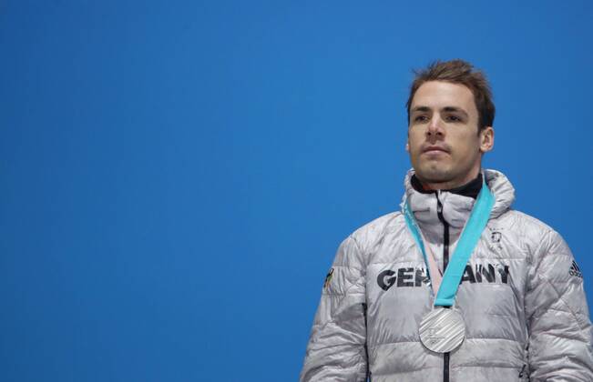OLYMPICS - 2018 Winter Olympics PYEONGCHANG,SOUTH KOREA,19.FEB.18 - OLYMPICS, BIATHLON - Olympic Winter games Winterspiele Spiele Summer games PyeongChang 2018, Medals Plaza, 15km Mass Start, men, award ceremony. Image shows Simon Schempp (GER). Keywords: medal. GEPAxpictures xAndreasxPranter
