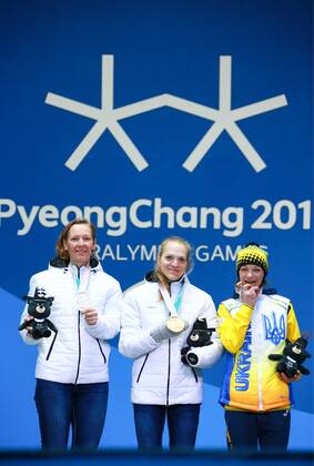 PYEONGCHANG, SOUTH KOREA - MARCH 13, 2018: Second- and first-placed neutral Paralympic athletes (NPA) from Russia Anna Milenina, Yekaterina Rumyantseva, and third-placed Liudmyla Liashenko (L-R) of Ukraine pose at a ceremony to award the women s 10km standing biathlon race winners at the 2018 Winter Paralympic Games. Vladimir Smirnov TASS  TS07770F