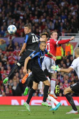 - MANCHESTER, UNITED KINGDOM: Club s Brandon Mechele, Club s Timmy Simons and Manchester s Wayne Rooney fight for the ball during a soccer game between British club Manchester United ManU FC and Belgian team Club Brugge KV in Manchester, United Kingdom, Tuesday 18 August 2015, the first leg of the play-offs for the UEFA Champions League competition. BRUNOxFAHY x84378591x