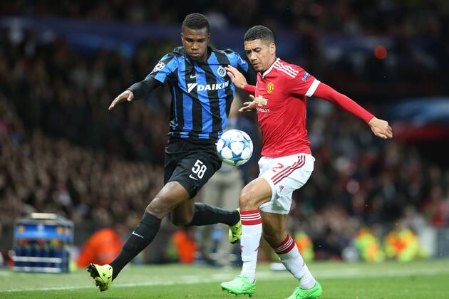 - MANCHESTER, UNITED KINGDOM: Club s Obbi Oulare and Manchester s Chris Smalling fight for the ball during a soccer game between British club Manchester United ManU FC and Belgian team Club Brugge KV in Manchester, United Kingdom, Tuesday 18 August 2015, the first leg of the play-offs for the UEFA Champions League competition. BRUNOxFAHY x84381904x