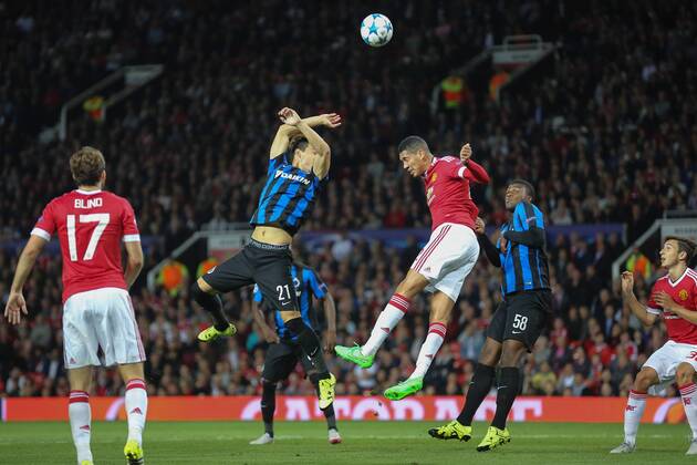 - MANCHESTER, UNITED KINGDOM: Club s Dion Cools, Manchester s Chris Smalling and Club s Obbi Oulare fight for the ball during a soccer game between British club Manchester United ManU FC and Belgian team Club Brugge KV in Manchester, United Kingdom, Tuesday 18 August 2015, the first leg of the play-offs for the UEFA Champions League competition. BRUNOxFAHY x84382013x