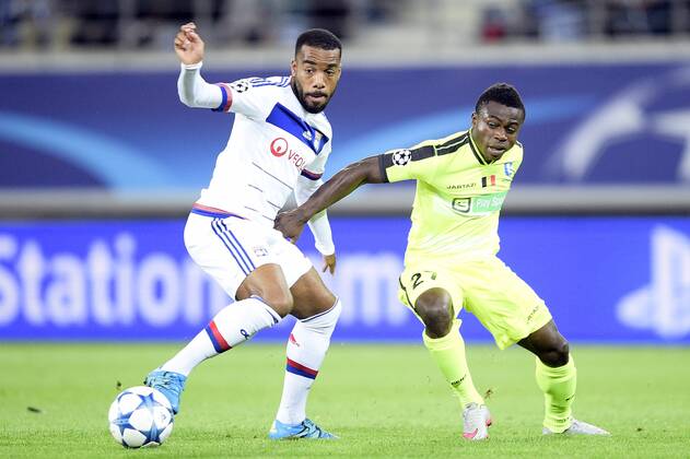 - GENT, BELGIUM: Lyon s Alexandre Lacazette and Gent s Moses Simon fight for the ball during the first game in the group stage of the Uefa Champions League competition, in group H, between Belgian first league soccer team KAA Gent and Olympique Lyon, in Gent, Wednesday 16 September 2015. YORICKxJANSENS x85279521x