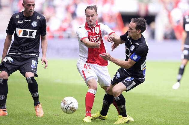 - LIEGE, BELGIUM: Standard d Francois Marquet and Gent s Sven Kums fight for the ball during the Jupiler Pro League match between Standard de Liege and AA Gent, in Liege, Sunday 10 August 2014, on the third day of the Belgian soccer championship. YORICKxJANSENS x61000211x