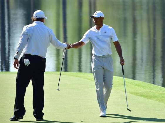 Phil Mickelson fist bumps Tiger Woods after Woods sunk a putt on the 16th green during a practice round prior to the Masters golf tournament at the Augusta National Golf Club, on April 3, 2018 in Augusta, Georgia.  AUG20180403321 KEVINxDIETSCH