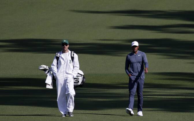 Tony Finau walks with caddie Greg Bodine in the 2nd round of the 2018 Masters Tournament at the Augusta National Golf Club in Augusta, Georgia, on April 6, 2018.  AUG20180406116 JOHNxANGELILLO
