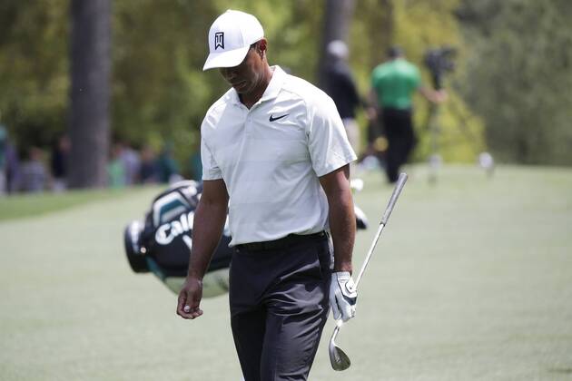 Tiger Woods puts his head down as he walks up the fairway after his approach shot on the first hole in the 2nd round of the 2018 Masters Tournament at the Augusta National Golf Club in Augusta, Georgia, on April 6, 2018.  AUG20180406125 JOHNxANGELILLO