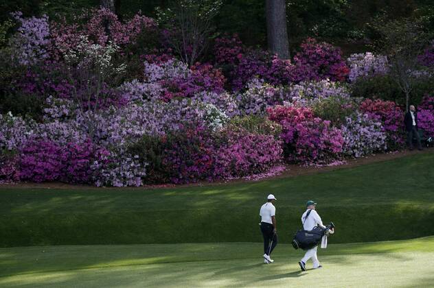 Tiger Woods and caddie Joe LaCava walk to the 13th green in the 2nd round of the 2018 Masters Tournament at the Augusta National Golf Club in Augusta, Georgia, on April 6, 2018.  AUG20180406148 JOHNxANGELILLO