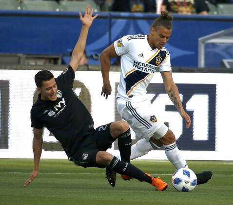April 8, 2018 - Los Angeles, California, U.S - Sporting Kansas Citys defender Amer Didic (2) vies with Los Angeles Galaxys defender Rolf Feltscher (25) of Switzerland during the 2018 Major League Soccer MLS Fussball Herren USA match between Los Angeles Galaxy and Sporting Kansas City in Carson, California, April 8, 2018. Sporting Kansas City won 2-0. MLS 2018: Los Angeles Galaxy 0-2 Sporting Kansas City - ZUMAc68_ 20180408_zaf_c68_001 Copyright: xRingoxChiux