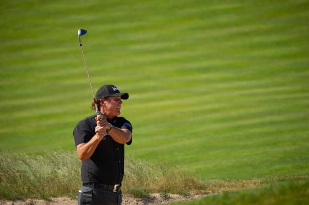 Phil Mickelson hits out of a bunker near the 11th green in the first round of the 118th U.S. Open Championship at Shinnecock Hills Golf Club in Southampton, New York on June 14, 2018.  NYP20180614123 COREYxSIPKIN