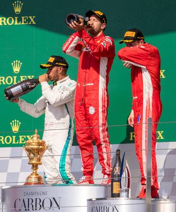 8th July 2018, Silverstone Circuit, Silverstone, England; British Formula One Grand Prix, Race Day; Scuderia Ferrari driver Sebastian Vettel and Mercedes driver Lewis Hamilton drink from the Champagne bottle  ActionPlus12045549 TimxWilliams
