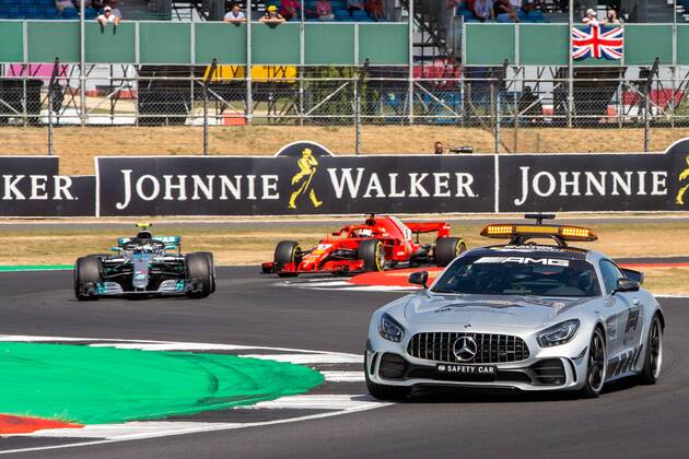 8th July 2018, Silverstone Circuit, Silverstone, England; British Formula One Grand Prix, Race Day; The safety car leads Valtteri Bottas in his Mercedes AMG Petronas Motorsport Mercedes F1 W09 and Sebastian Vettel in his Scuderia Ferrari SF71H  ActionPlus12045559 TimxWilliams