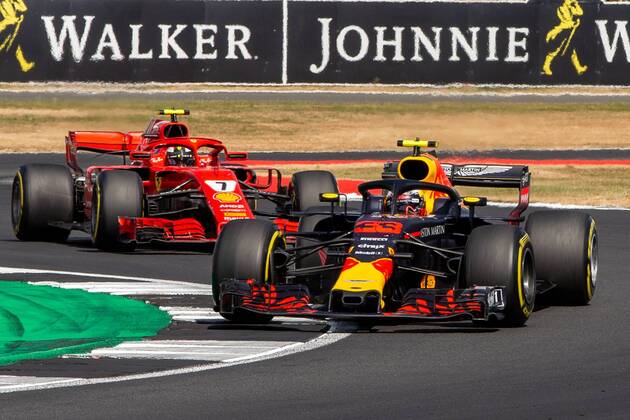 8th July 2018, Silverstone Circuit, Silverstone, England; British Formula One Grand Prix, Race Day; Max Verstappen in his Aston Martin Red Bull Racing Red Bull Racing TAG Heuer RB14 ahead of Kimi Raikkonen in his Scuderia Ferrari SF71H  ActionPlus12045562 TimxWilliams