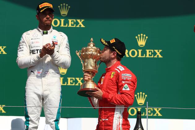 8th July 2018, Silverstone Circuit, Silverstone, England; British Formula One Grand Prix, Race Day; Scuderia Ferrari, Sebastian Vettel wins at Silverstone and kisses his trophy  ActionPlus12045576 Octane