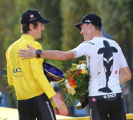 Geraint Thomas (L) and teammate Chris Froome of Great Britain celebrate on the presentation podium after Thomas won the Tour de France in Paris on July 29, 2018. Thomas claimed his first Tour de France victory, becoming the first Welshman to win the event.  PAR20180729012 DAVIDxSILPA