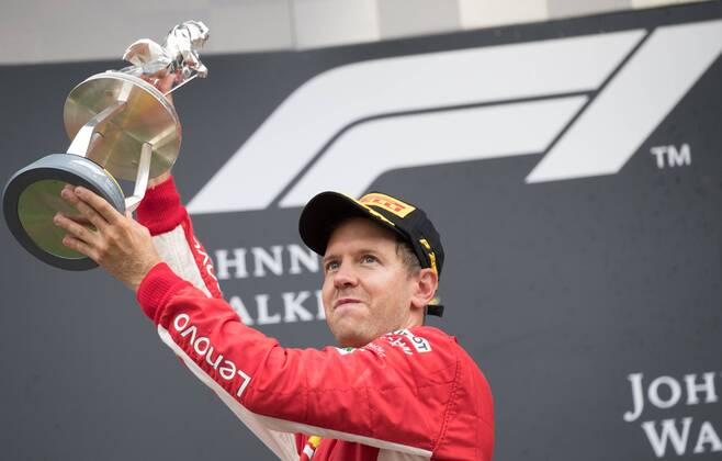 Ferrari s German driver Sebastian Vettel celebrates on the podium after winning the Spa-Francorchamps Formula One Grand Prix of Belgium race, in Spa-Francorchamps, Sunday 26 August 2018. BENOITxDOPPAGNE x05414419x