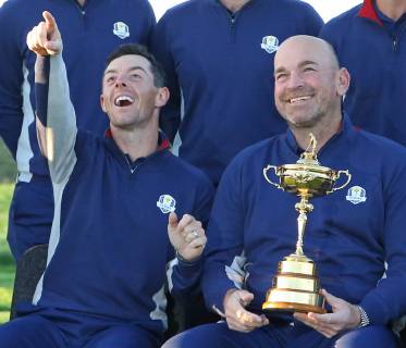 Rory McIlroy and Ryder Cup European team captain Thomas Bjorn arrive for a team photo at Le Golf National in Guyancourt near Paris on September 25, 2018.  PAR20180925056 DAVIDxSILPA