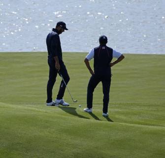 Dustin Johnson (L) and Rickie Fowler chat on the green on day two of the Ryder Cup at Le Golf National in Guyancourt near Paris on September 29, 2018. Johnson and Fowler lost their match to Paul Casey and Tyrrell Hatton 3 & 2.  PAR20180929013 DAVIDxSILPA