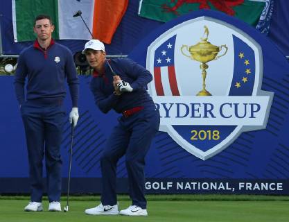 Rory McIlroy (L) and Thorbjorn Olesen arrive on the first tee before the start of the Ryder Cup at Le Golf National in Guyancourt near Paris on September 28, 2018.  PAR20180929104 DAVIDxSILPA
