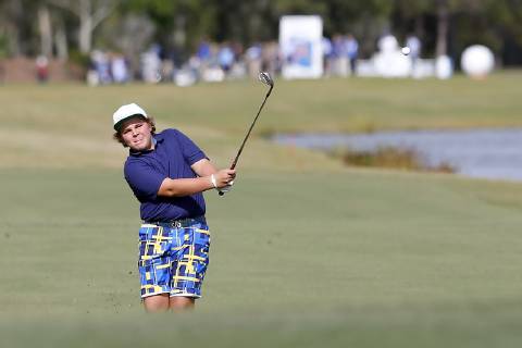 ORLANDO, FL - DECEMBER 13: Little John Daly, son of John Daly, chips onto the 18th green during the Pro-Am of the 2018 PNC Father Son Challenge on December 13, 2018 at the The Ritz-Carlton Golf Club in Orlando, Florida. (Photo by Cliff Welch Icon Sportswire) GOLF: DEC 13 Champions Tour - PNC Father Son Challenge Icon121318116 EDITORIAL USE ONLY