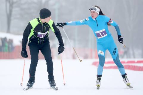 MINSK, BELARUS - FEBRUARY 9, 2019: Belarusian President Alexander Lukashenko s son Nikolai (L) and biathlete Daria Domracheva take part in a relay race as part of the 2019 Minsk Ski Track event in Vesnyanka District. The President s team including his son Nikolai, personal physician Svetlana Konoshenko, and Belarusian biathlete, four-time Olympic champion Daria Domracheva, has won the relay race. Natalia Fedosenko TASS TS0A0731