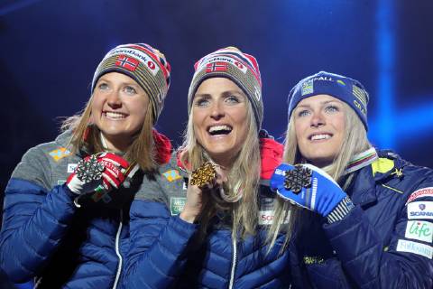 SEEFELD, TIROL, AUSTRIA â€“ MARCH 2, 2019: Cross-country skiers Ingvild Flugstad Ostberg (silver) of Norway, Therese Johaug (gold) of Norway, and Frida Karlsson (bronze) of Sweden, from left, pose at a medal ceremony for the ladies 30km mass start race at the 2019 FIS Nordic World Ski Championships. Sergei Bobylev TASS  TS0A2FC8