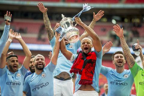 Vincent Kompany of Manchester City and his team mates lift the FA Trophy during The FA Cup Final match between Manchester City and Watford at Wembley Stadium, London, England on 18 May 2019. Copyright: xSalvioxCalabresex 24040056