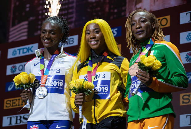 (191001) -- DOHA, Oct. 1, 2019 -- Shelly-Ann Fraser-Pryce (C) of Jamaica, Dina Asher-Smith (L) of Britain and Marie-Josee Ta Lou of Cote d Ivoire pose for photos during the awarding ceremony of the women s 100m final at the 2019 IAAF World Athletics Championships in Doha, Qatar, Sept. 30, 2019. ) (SP)QATAR-DOHA-IAAF WORLD ATHLETICS CHAMPIONSHIPS-WOMEN S 100M-AWARDING CEREMONY WangxJingqiang 