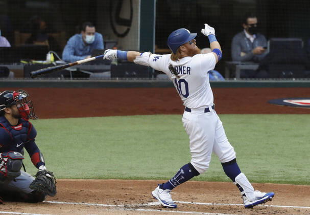 Baseball: NL Championship Series Justin Turner of the Los Angeles Dodgers hits a solo home run in the first inning in Game 6 of the NL Championship Series against the Atlanta Braves on Oct. 17, 2020, in Arlington, Texas. 