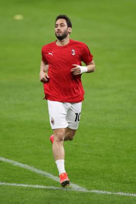 Hakan Calhanoglu of AC Milan during the warm up prior to the UEFA Europa League match at Giuseppe Meazza, Milan. Picture date: 25th February 2021. Picture credit should read: Jonathan Moscrop Sportimage EDITORIAL USE ONLY. No use with unauthorised audio, video, data, fixture lists, club league logos or live services. Online in-match use limited to 120 images, no video emulation. No use in betting, games or single club league player publications. SPI-0923-0099