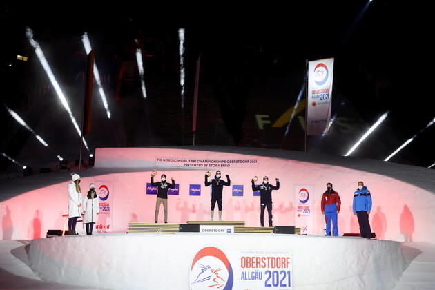 NORDIC SKIING - FIS Nordic World Ski Championships Oberstdorf 2021 OBERSTDORF,GERMANY,27.FEB.21 - NORDIC SKIING, NORDIC COMBINED - FIS Nordic World Ski Championships, men, award ceremony. Image shows the rejoicing of Ilkka Herola (FIN), Jarl Magnus Riiber and Jens Luraas Oftebro (NOR). GEPAxpictures xChristianxWalgram