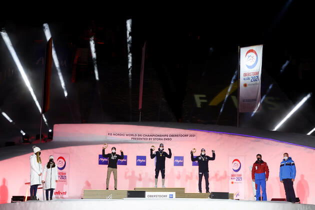 NORDIC SKIING - FIS Nordic World Ski Championships Oberstdorf 2021 OBERSTDORF,GERMANY,27.FEB.21 - NORDIC SKIING, NORDIC COMBINED - FIS Nordic World Ski Championships, men, award ceremony. Image shows the rejoicing of Ilkka Herola (FIN), Jarl Magnus Riiber and Jens Luraas Oftebro (NOR). GEPAxpictures xChristianxWalgram
