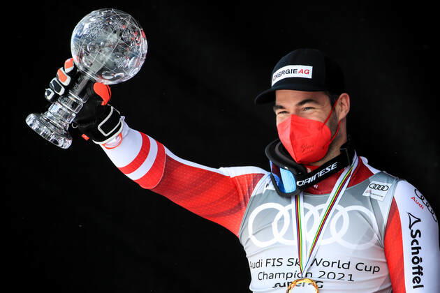 ALPINE SKIING - FIS WC Final Lenzerheide LENZERHEIDE,SWITZERLAND,18.MAR.21- ALPINE SKIING - FIS World Cup Final, award ceremony for the Super G World Cup, men. Image shows the rejoicing of Vincent Kriechmayr (AUT). Keywords: crystal globe, medal. GEPAxpictures xMarioxBuehner
