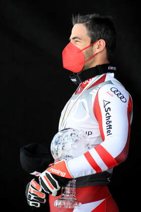ALPINE SKIING - FIS WC Final Lenzerheide LENZERHEIDE,SWITZERLAND,18.MAR.21- ALPINE SKIING - FIS World Cup Final, award ceremony for the Super G World Cup, men. Image shows Vincent Kriechmayr (AUT). Keywords: crystal globe, medal. GEPAxpictures xMarioxBuehner