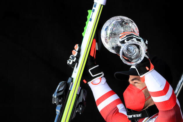 ALPINE SKIING - FIS WC Final Lenzerheide LENZERHEIDE,SWITZERLAND,18.MAR.21- ALPINE SKIING - FIS World Cup Final, award ceremony for the Super G World Cup, men. Image shows the rejoicing of Vincent Kriechmayr (AUT). Keywords: crystal globe, medal. GEPAxpictures xMarioxBuehner