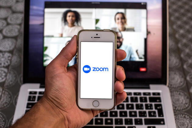 April 20, 2021, Barcelona, Catalonia, Spain: In this photo illustration, the Zoom app seen displayed on a smartphone screen and a Zoom Desktop on a laptop in the background. Barcelona Spain - ZUMAd159 20210420_zia_d159_092 Copyright: xThiagoxPrudenciox