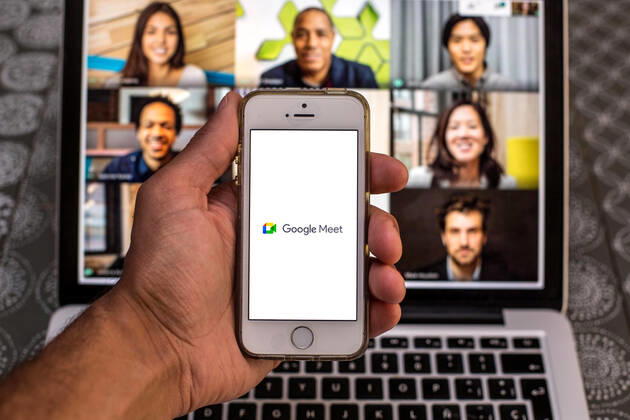 April 20, 2021, Barcelona, Catalonia, Spain: In this photo illustration, the Google Meet app seen displayed on a smartphone screen and a Google Meet Desktop on a laptop in the background. Barcelona Spain - ZUMAd159 20210420_zia_d159_095 Copyright: xThiagoxPrudenciox